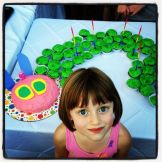 A girl and her Very Hungry Caterpillar.